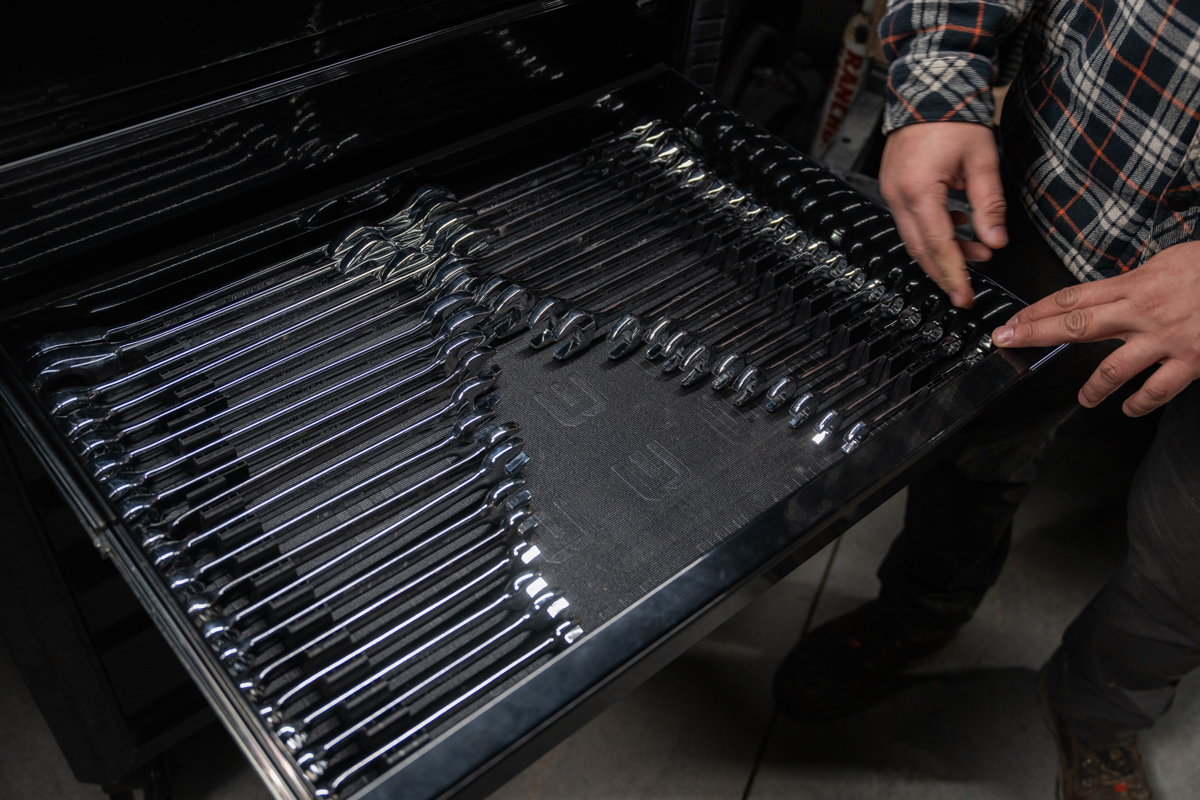 Angled top-down view of a tool drawer with wrenches organized in a uniform, space-saving manner