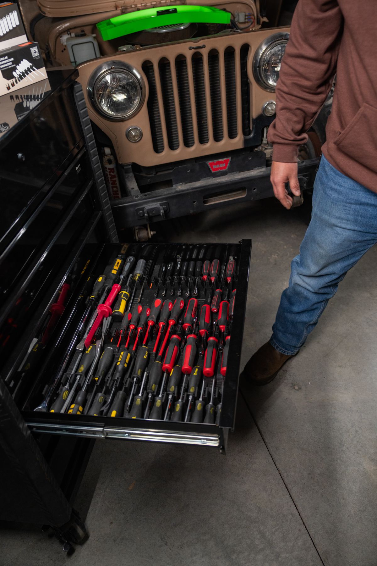 Storage drawer with various tool organizers including wrenches and pliers