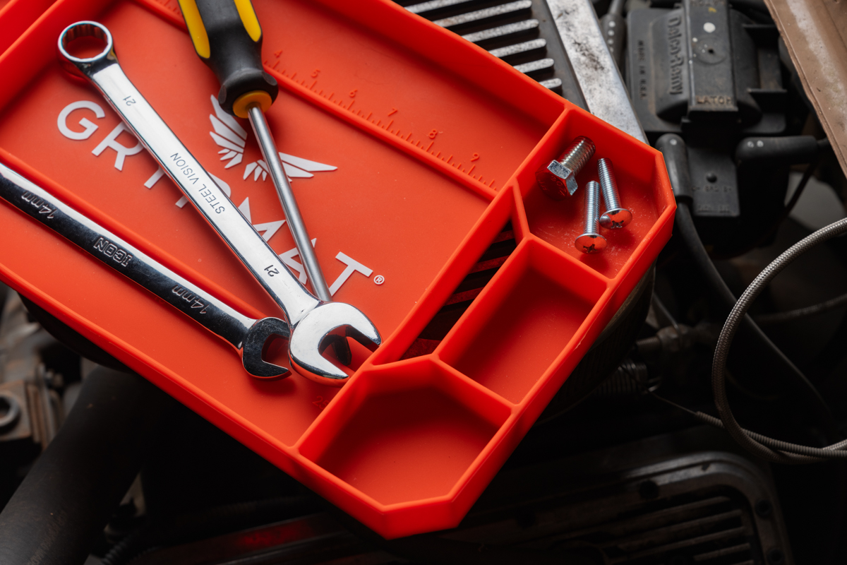 Orange Grypmat tray showing logo and measurement markings