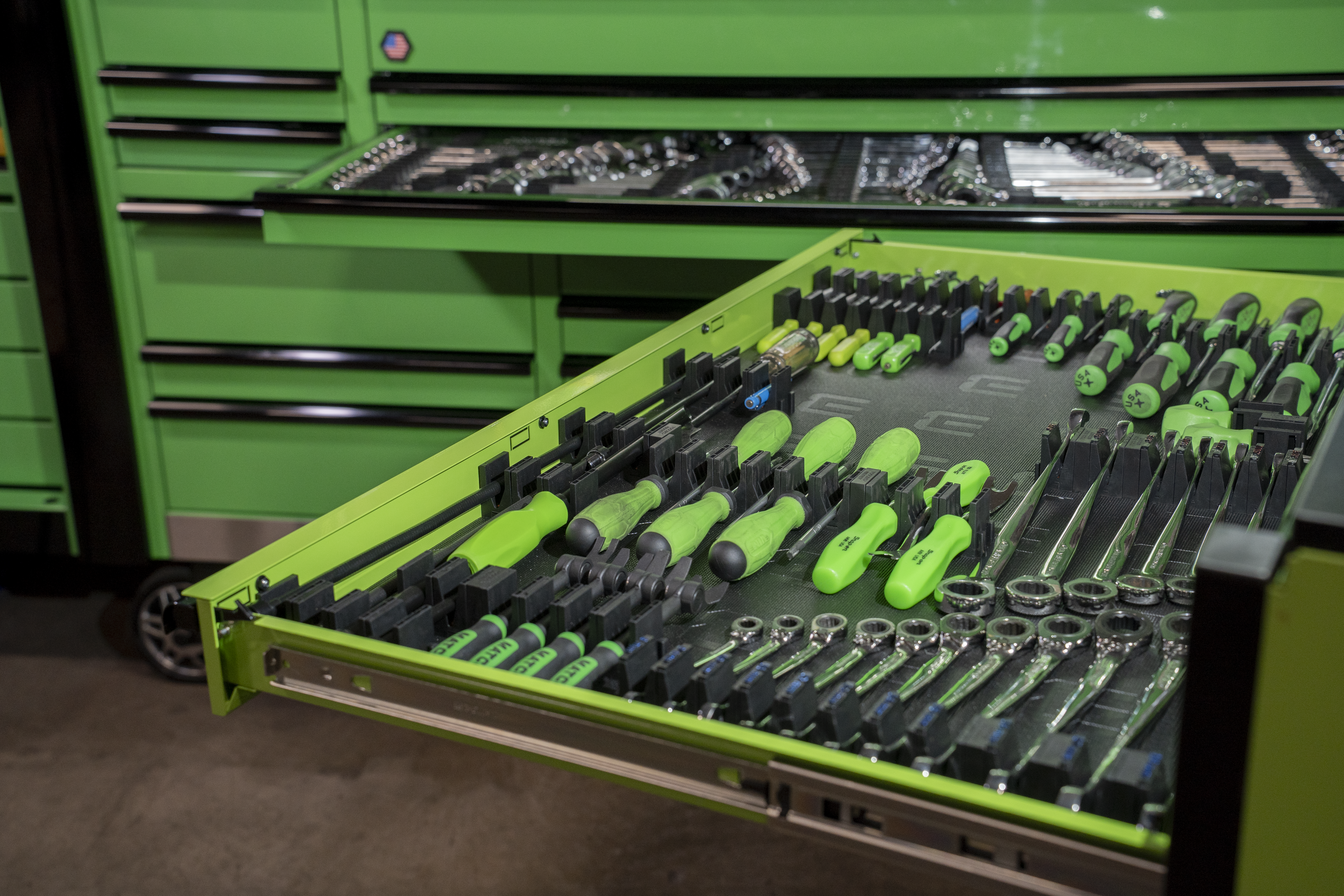 Tool chest drawer filled with screwdrivers in organized modular inserts